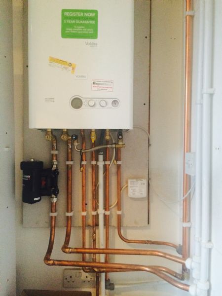 vokera bolier with control panel and pipes below it